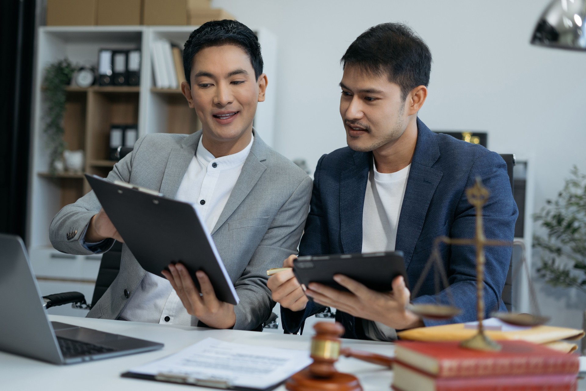 Teamwork of business lawyer meeting working hard about legal legislation in courtroom to help their customer.